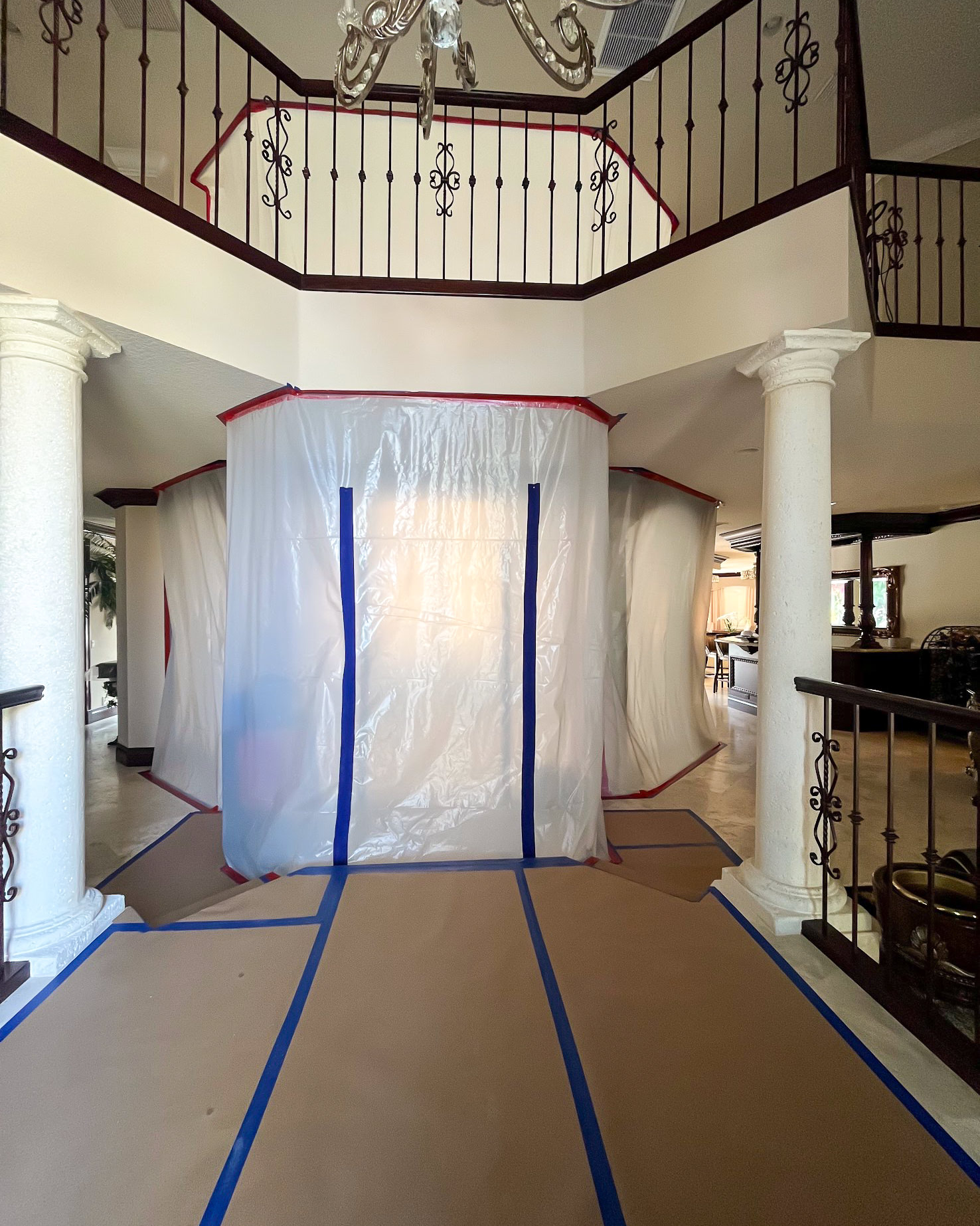 Full plastic containment setup in large home during restoration