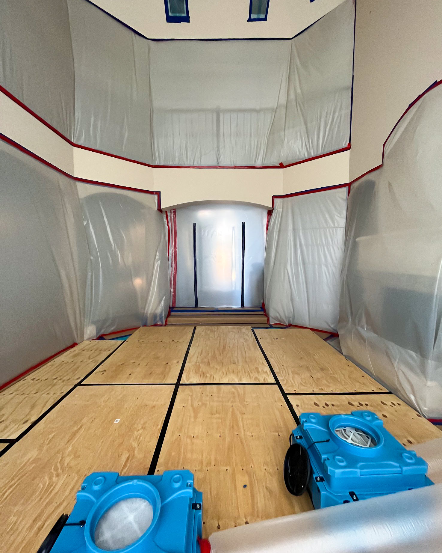 Inside catastrophe containment corridor with industrial air movers