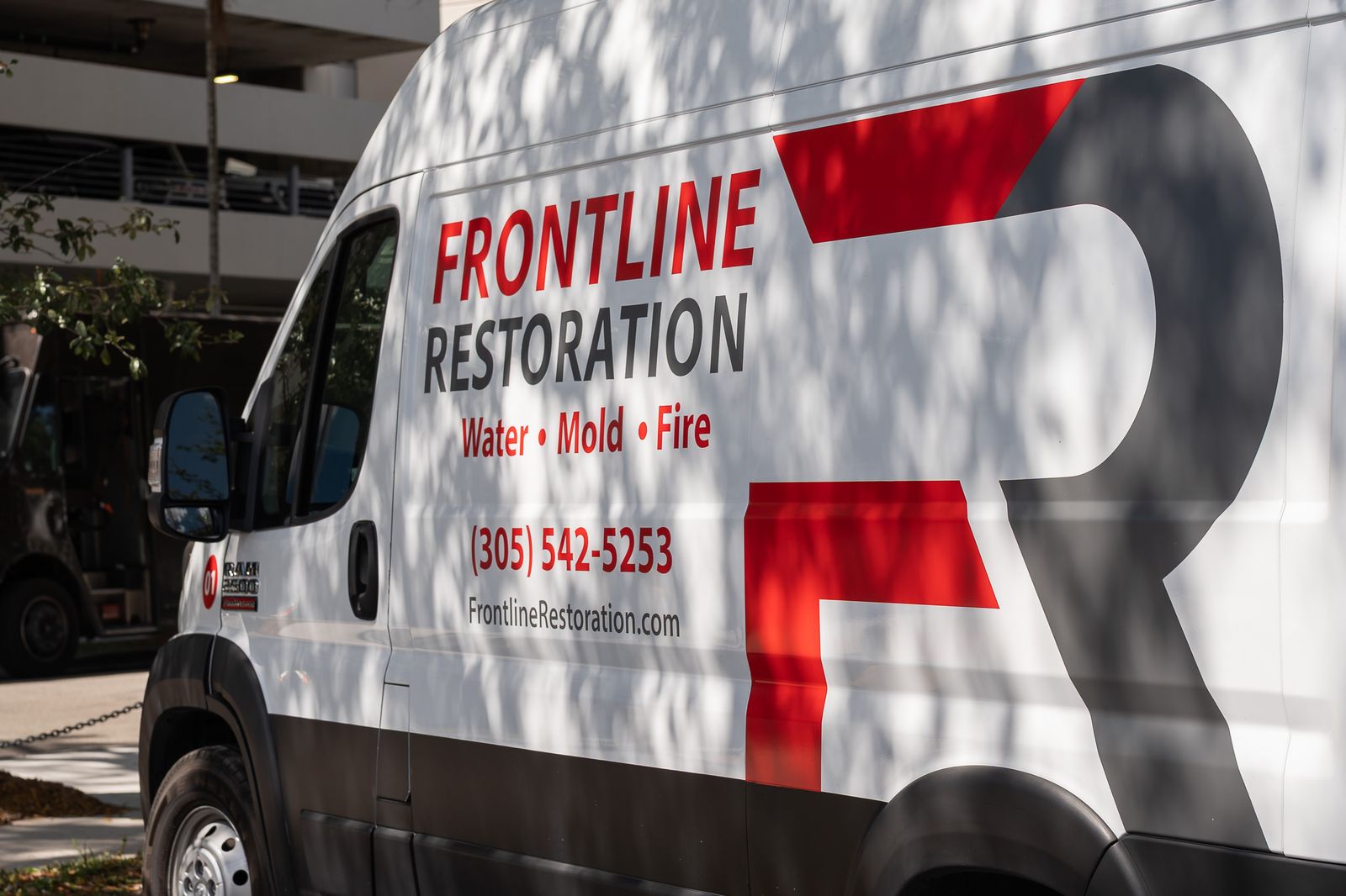Frontline Restoration van with the phone number on its side